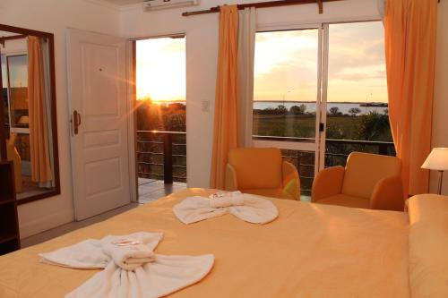 a room with a table with towels on it with a window at Brisas del Lago Apart y Hotel in Federación