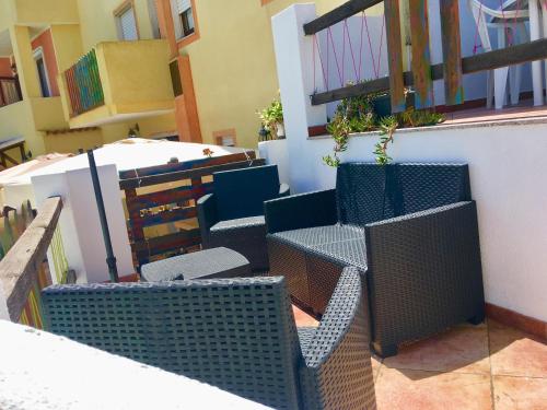 a group of chairs sitting on top of a balcony at Apartment Maria in Tergu
