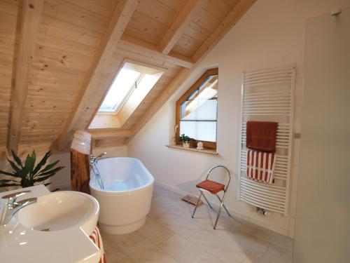 a bathroom with a white tub and a sink at Naturparkhotel Schwarzwaldhaus in Bernau im Schwarzwald