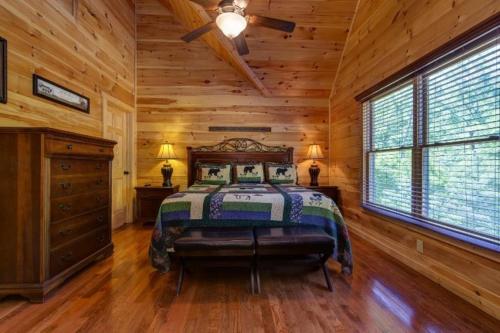 1 dormitorio con 1 cama en una habitación de madera en Grand View Lodge House Home, en Pigeon Forge
