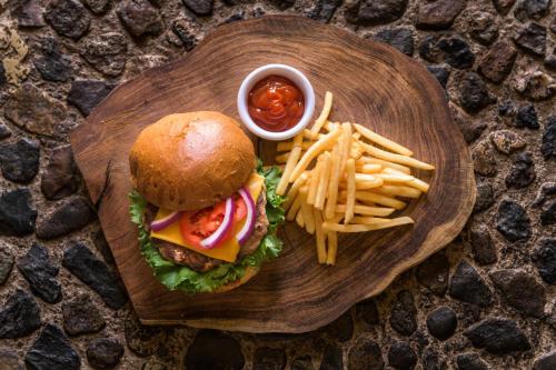 a plate of food with a hamburger and french fries at Tapalpa Country Club Hotel in Tapalpa