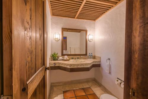 a bathroom with a sink and a mirror at Tapalpa Country Club Hotel in Tapalpa