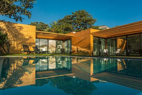 a house with a pool in front of it at Quinta do Passo in Ribeira Grande