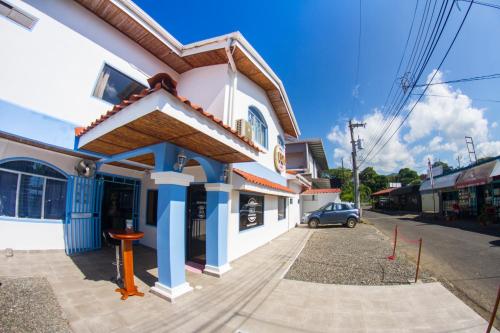 a building with blue columns on a street at Hotel IBIZA Beach Boutique in Jacó