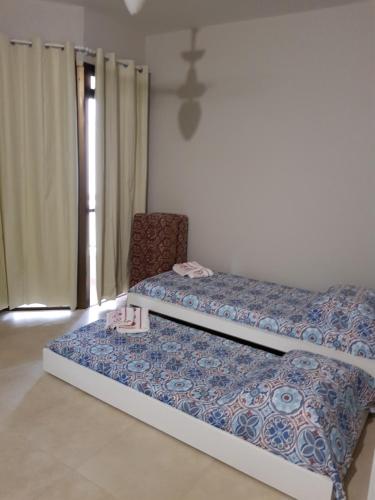 A bed or beds in a room at Boulevard Ponta Das Canas