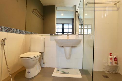 a bathroom with a toilet and a sink at G Beach Front Villa in Batu Ferringhi