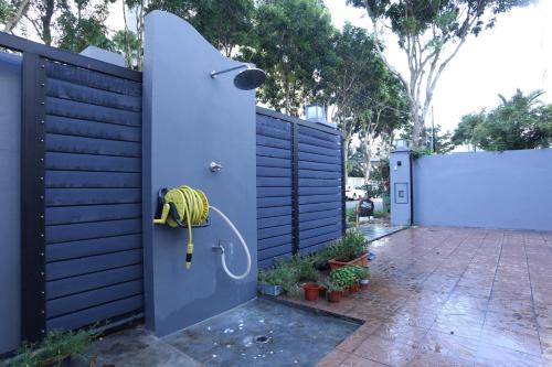 a blue fence with a door with a banana on it at G Beach Front Villa in Batu Ferringhi