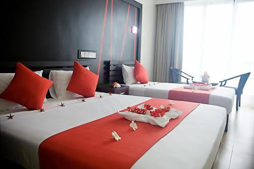Säng eller sängar i ett rum på Nasau Resort & Villas
