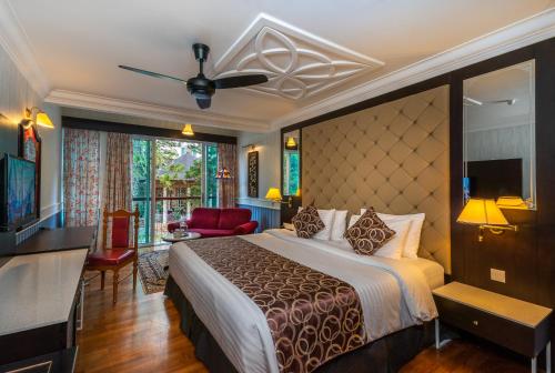 a hotel room with a bed and a television at Century Pines Resort Cameron Highlands in Cameron Highlands