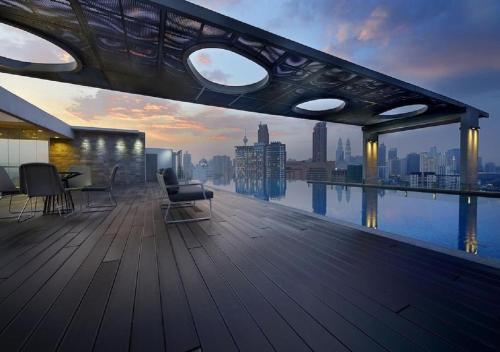 a balcony of a building with a view of the city at Maxhome @ D'Majestic Place, KL City Centre in Kuala Lumpur