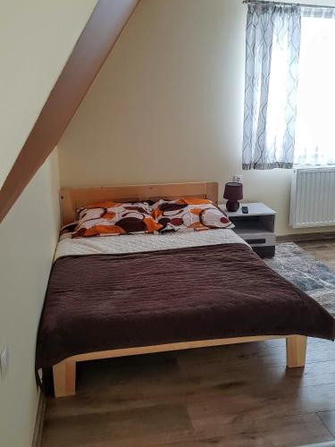 a bedroom with a bed in a attic at Apartamenty u Klisia in Ząb