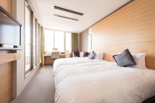Postel nebo postele na pokoji v ubytování K's Street Hotel Miyazaki