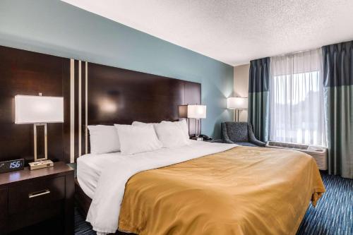 a hotel room with a large bed and a window at Quality Inn in Gordonsville