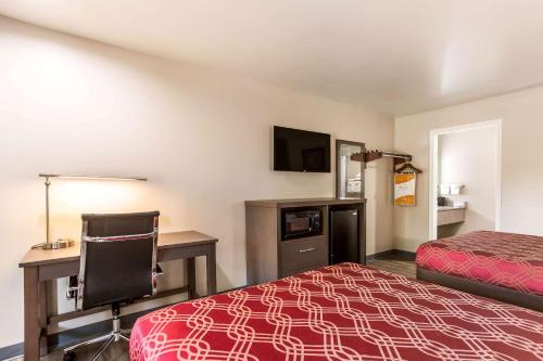 a hotel room with a bed and a desk at Econo Lodge Inn & Suites Murfreesboro Shopping District in Murfreesboro