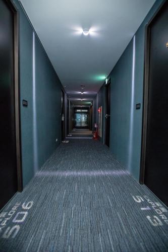 an empty corridor of an office building with blue walls at Explore Hotel in Taichung