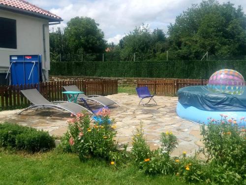 a backyard with a play set and a trampoline at Villa Kalin in Natsovtsi