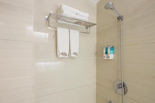 a bathroom with a shower with towels on a wall at YOYO INTERNATIONAL Apartment in Guangzhou