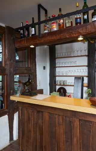 a bar in a kitchen with wooden walls at Reiterhof Zwei Linden in Melle