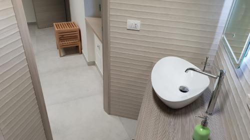a bathroom with a white toilet and a sink at Villa Tina ai Piedi del Faro di Leuca in Leuca