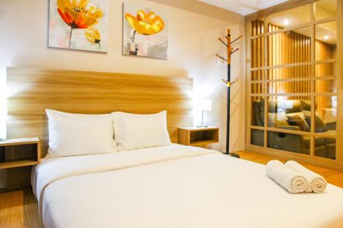 Postel nebo postele na pokoji v ubytování Scandinavian Japanese Style Studio The Oasis Apartment By Travelio