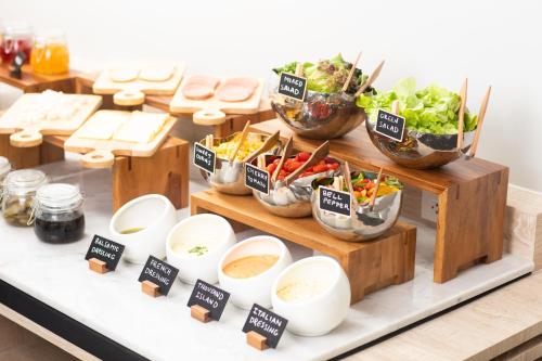a buffet with bowls of food on a table at LIV Hotel Phuket Patong Beachfront in Patong Beach