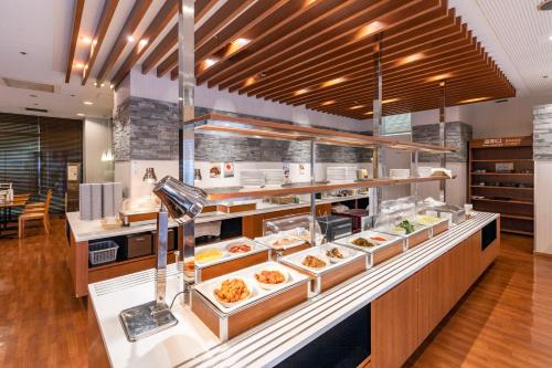 a buffet in a restaurant with a lot of food at Nishitetsu Inn Kurosaki in Kitakyushu