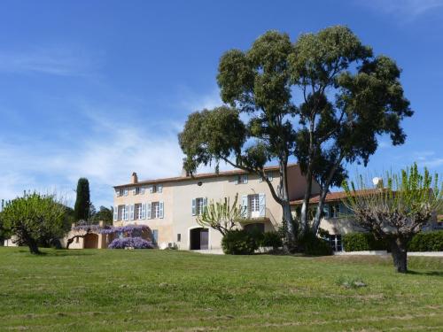 a large building with trees in front of it at Residence Les Sellettes in Saint-Tropez