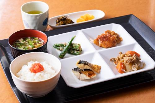 a plate of food with rice and vegetables and a cup of coffee at Nishitetsu Inn Kurosaki in Kitakyushu