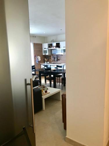 a view of a dining room and kitchen from a doorway at Appartamento Centralissimo - Abetone in Abetone