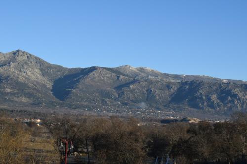 a view of a mountain range with mountains in the background at Hospederia La Cañada in Moralzarzal