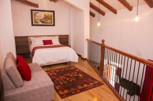 a bedroom with a bed and a couch in a room at La Casona Monsante in Chachapoyas