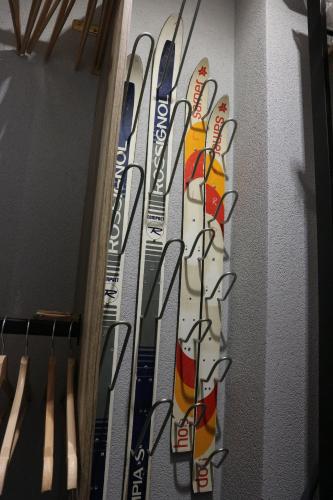 a group of skis are lined up on a wall at Hameau du Borsat in Tignes