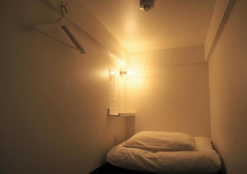 A bed or beds in a room at almond hostel & cafe Shibuya