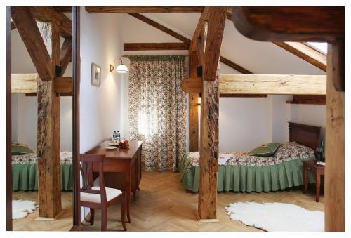 a bedroom with a bed and a desk in a room at Pałac Łochów in Łochów