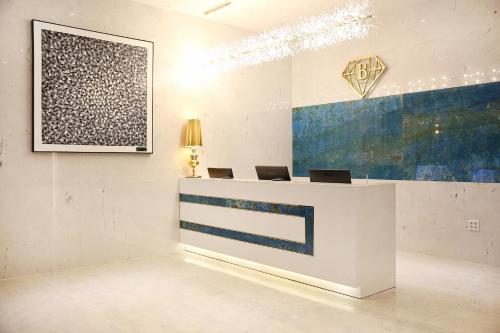 a reception desk in a room with two laptops on it at Baymond Hotel in Busan