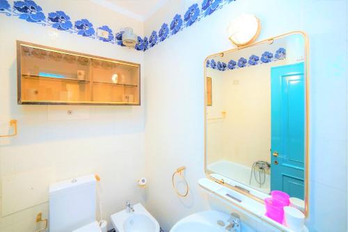 a bathroom with a toilet and a sink and a mirror at La Finestra sul Mare in Portovenere