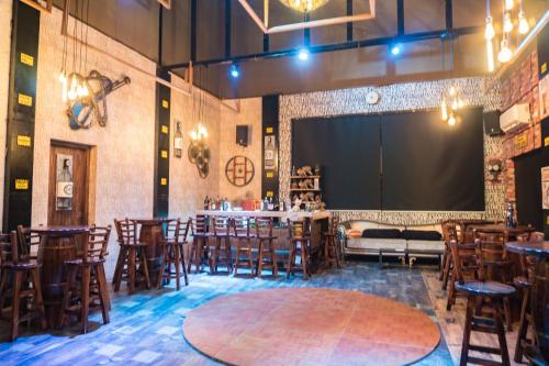 a large room with tables and chairs and a large screen at Kushal Palli Resorts- A unit of PearlTree Hotels & Resorts in Purulia