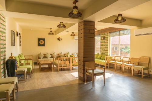 a living room with chairs and tables at Kushal Palli Resorts- A unit of PearlTree Hotels & Resorts in Purulia