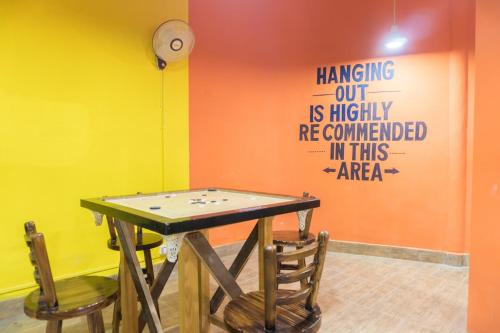 a ping pong table in a room with two chairs at Kushal Palli Resorts- A unit of PearlTree Hotels & Resorts in Purulia