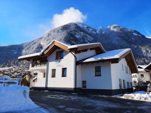 a building with a mountain in the background at Haus Marieus in Umhausen