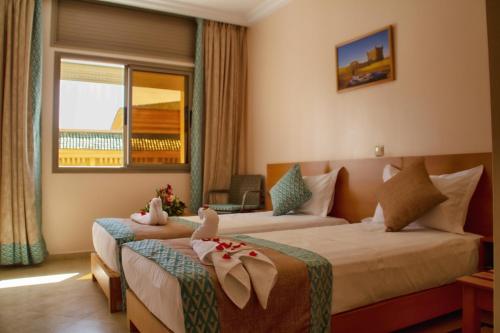 Llit o llits en una habitació de Hotel Al Mamoun