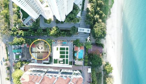 an overhead view of a building next to the ocean at G Beach Front Villa in Batu Ferringhi