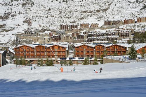 a group of people in the snow in front of a hotel at Hotel Nordic in El Tarter