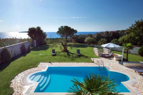 a swimming pool with a view of the ocean at Panorama Villas in Arillas