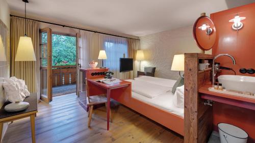 a hotel room with a bed and a sink at Hotel Oberstdorf in Oberstdorf
