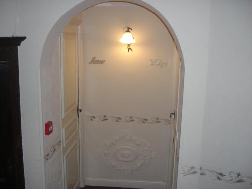 an archway with a light on top of a door at La Marjolaine in Juan-les-Pins