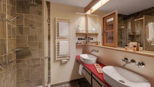 a bathroom with a sink and a shower at Hotel Oberstdorf in Oberstdorf