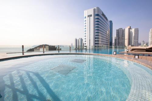 a large swimming pool on the roof of a building at Baymond Hotel in Busan
