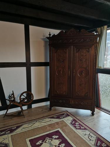 a large wooden cabinet in a room with a rug at Ferienhof Schmickerath in Simmerath