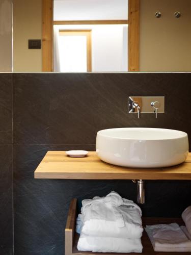 a bathroom with a sink and a mirror at FIORI Dolomites Experience Hotel in San Vito di Cadore